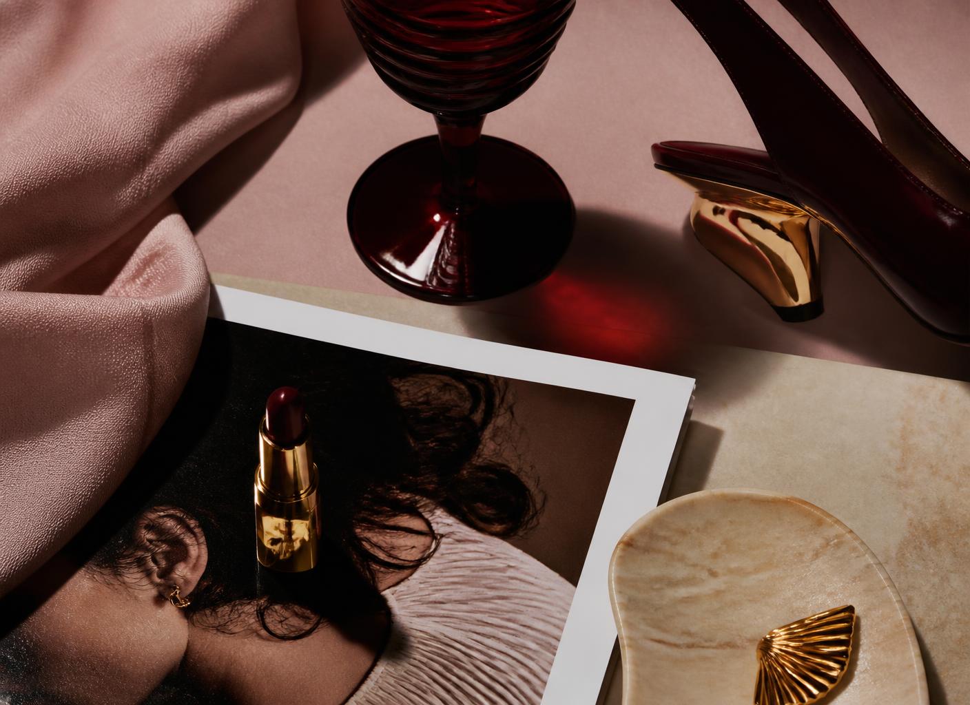 Editorial still life moodboard of six brand objects on a blush background